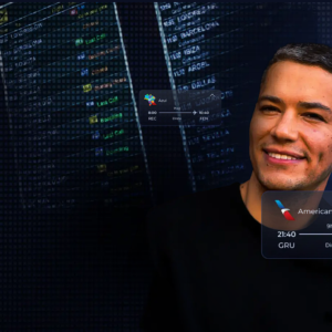 a man smiling in front of a computer screen